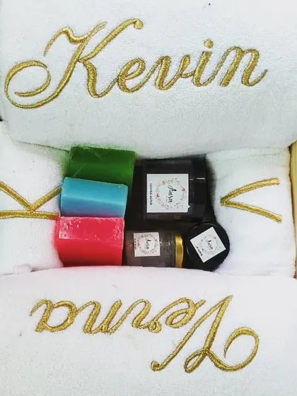 This luxurious couple's gift hamper features white towels with elegant gold embroidery for the bride and groom. It's paired with a selection of my colorful, handmade cold-process soaps and other spa essentials.