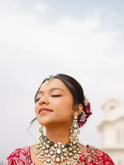 The bride closes her eyes and smiles, basking in the sun on the palace rooftop. This is a moment of pure, unadulterated happiness, beautifully captured.
