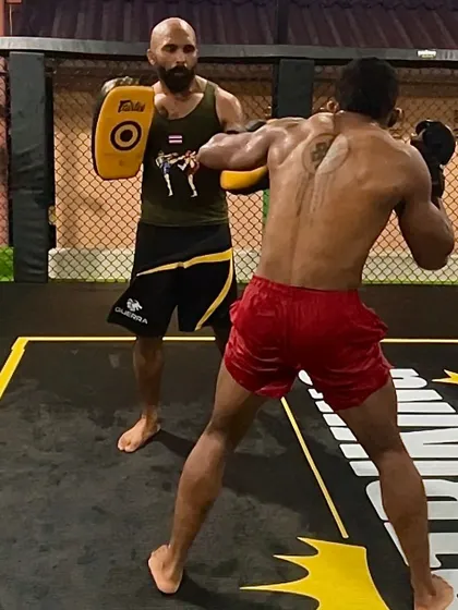 Step by step, we build a fighter. Holding pads for Muay Thai drills, focusing on technique.