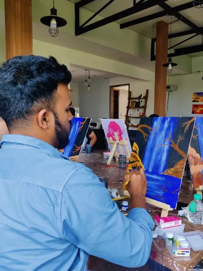 A painter adding details to his waterfall scene. The concentration and creativity in the room are always so inspiring to see.