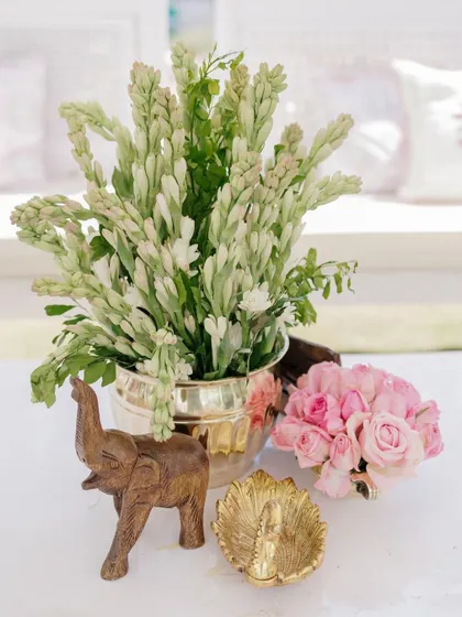 A small wooden elephant and a brass leaf dish are part of the charming, traditional decor.