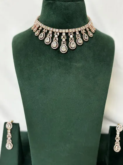 A full view of the rose-gold plated American diamond choker with matching earrings. A chic and modern rental option.