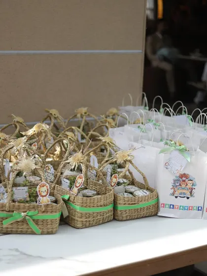 For a jungle-themed party, we prepared these charming return gifts in wicker baskets and custom-printed bags.