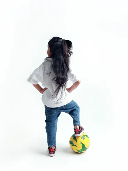 A pre-mundan shoot celebrating her beautiful long hair. This pose, with her foot on the ball, is full of confidence and sass.