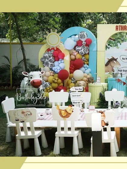 Another view of the charming kids' dining table at the farm party, with custom animal-themed chairs.