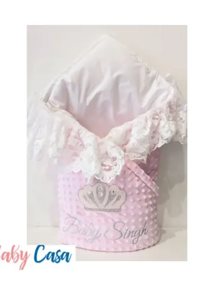 Soft, cuddly, and oh so pretty. This pink minky dot wrap is personalized with "Baby Singh" and features a rhinestone crown and delicate lace trim for a touch of sparkle.