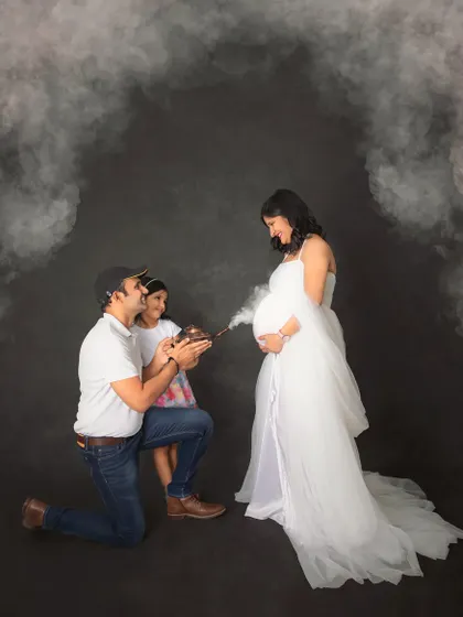 A creative and fun way to announce your baby's arrival. Here, the family uses a whimsical smoke effect from an old-fashioned lamp to reveal the magic of their growing family.