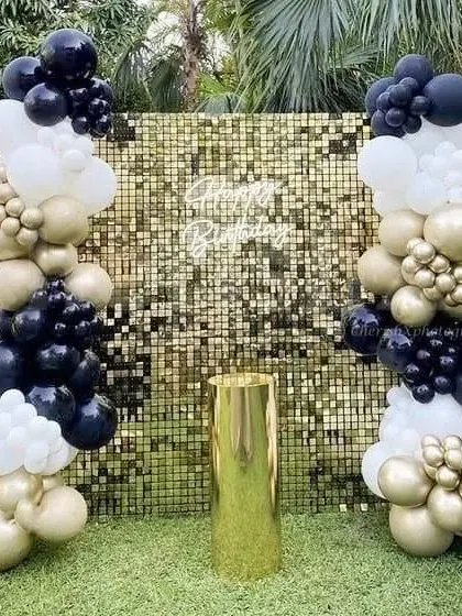 This outdoor 25th birthday party setup is all about glamour. I used a circular balloon arch against a green hedge wall, a "Happy Birthday" neon sign, and large, illuminated marquee numbers to create a stunning photo-op area for the celebration.