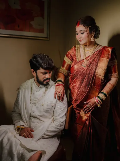An elegant, posed portrait taken away from the main ceremony. The dramatic lighting and classic pose give this shot a timeless, regal feel.