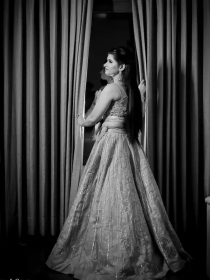 A beautiful black and white portrait of the bride-to-be on her engagement day. She looks out the window, creating a thoughtful and elegant silhouette.