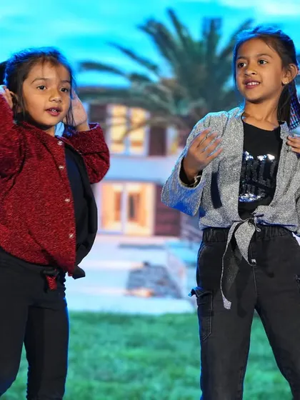 Two girls perform a modern dance routine, showcasing their coordination and stage presence.