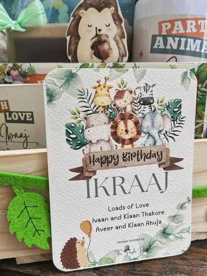 The personalized birthday card for the jungle hamper, featuring the birthday boy's name, Ikraaj, and a collection of cute safari animals.