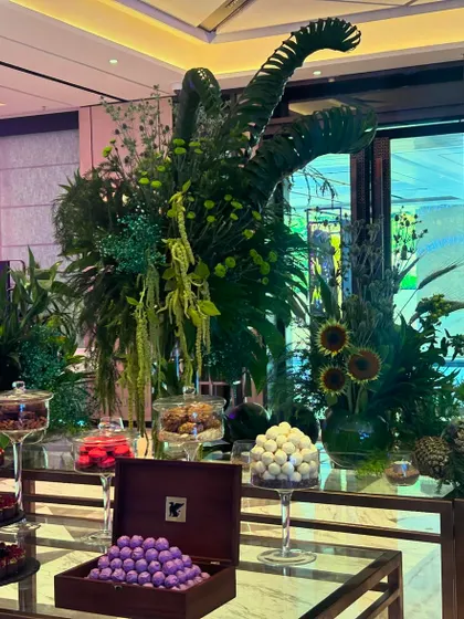 The combination of lush greenery and decadent chocolates creates an irresistible and luxurious experience for guests.