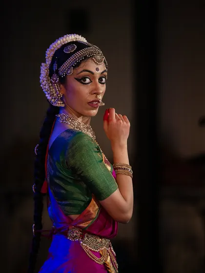 A glance over the shoulder, a classic pose in Indian dance filled with meaning. It can convey coyness, curiosity, or a backward glance at a loved one.