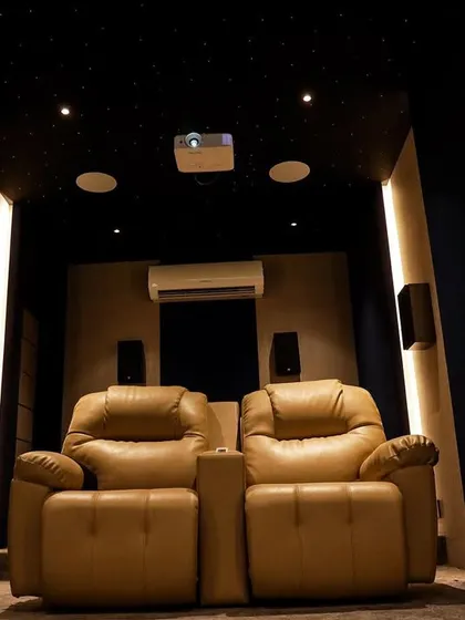 A head-on view of the two comfortable leather recliners, perfectly positioned for an optimal stereo and visual experience.