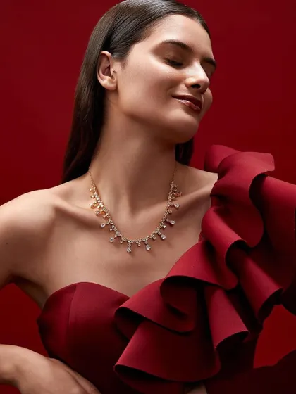 A joyful and elegant moment from the campaign. This shot feels celebratory and luxurious, perfect for a festive collection.