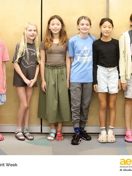 Students proudly show off their unique sock and sandal combinations. These simple, fun activities are an important part of building a positive and inclusive middle school environment.