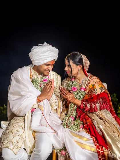 A moment of prayer and gratitude during their beach wedding ceremony. The couple sits together, sharing a look of peace and mutual respect.
