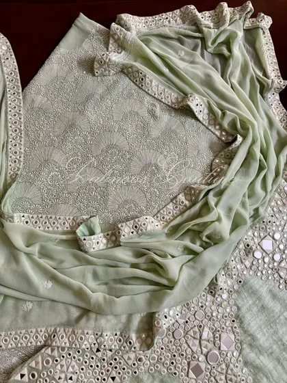 A complete view of the mint green suit, showing the interplay between the dense Chikankari on the kurta and the bold mirrorwork on the palazzo and dupatta.