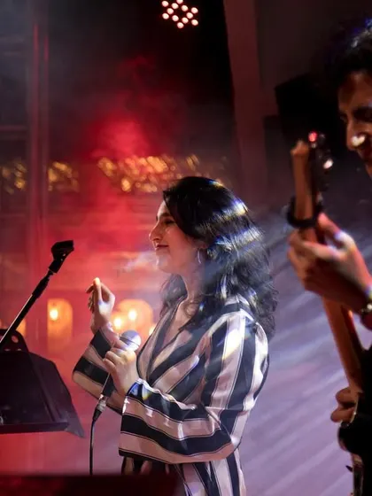 Sharing a smile on stage with my guitarist. The non-verbal communication between us during a live set is key to a seamless performance.