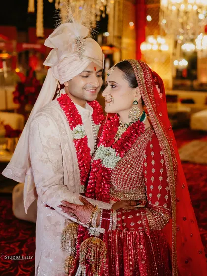 A close-up of the couple sharing a happy, loving look during their grand wedding at the ITC Grand Bharat.