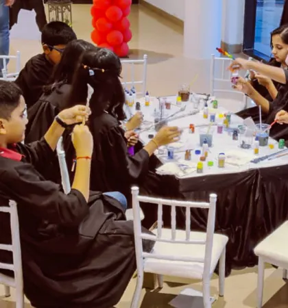 Young wizards in their robes, gathered around a table filled with potion ingredients and wands. This is where they learn the science behind the spells.