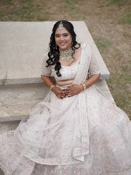 A full-length view of her reception look. The simple yet stunning necklace adds a touch of sparkle without taking away from her beautiful outfit.