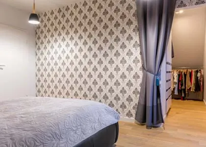A classic damask pattern in a bedroom, creating a cozy and traditional feel. This timeless design adds a sense of comfort and elegance.