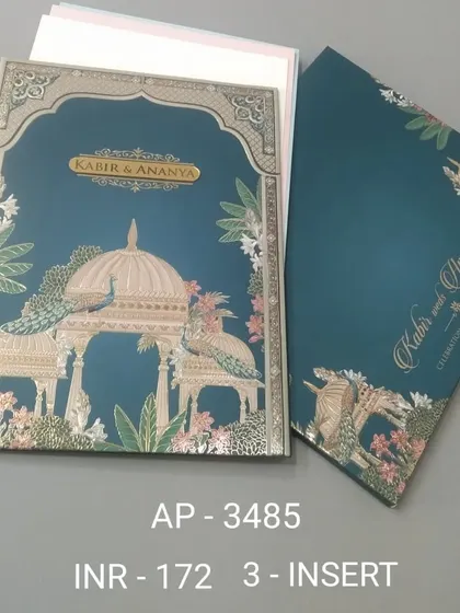 A rich teal invitation featuring peacocks perched on a gazebo, with silver foil accents. This three-insert card is perfect for an elegant evening ceremony or reception.