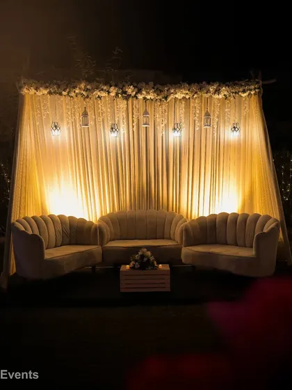 We create cozy and stylish lounge areas like this cabana setup. The plush, shell-shaped velvet sofas under a beautifully draped and lit canopy provide a comfortable and chic space for guests to relax and socialize.