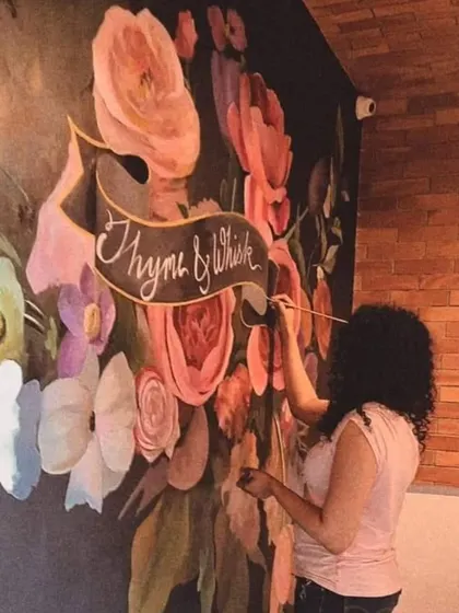 Floral art is a signature part of my work. Here I am adding the final touches to a large-scale floral mural for the Thyme & Whisk restaurant. I believe bringing elements of nature indoors adds a unique energy and beauty to any commercial space.
