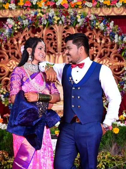 A stylish shot of the couple interacting candidly on their wedding reception stage.