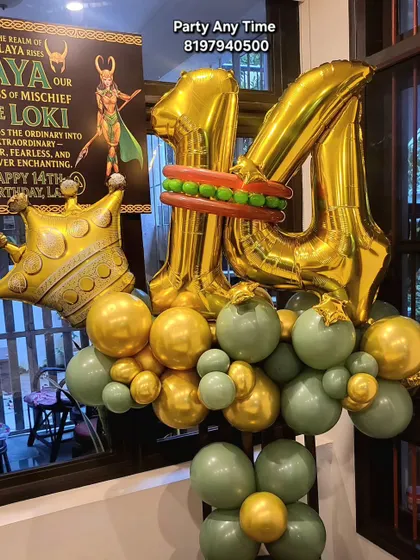 A fun 14th birthday bouquet with a Loki theme, featuring gold foil numbers and a green and gold balloon base.