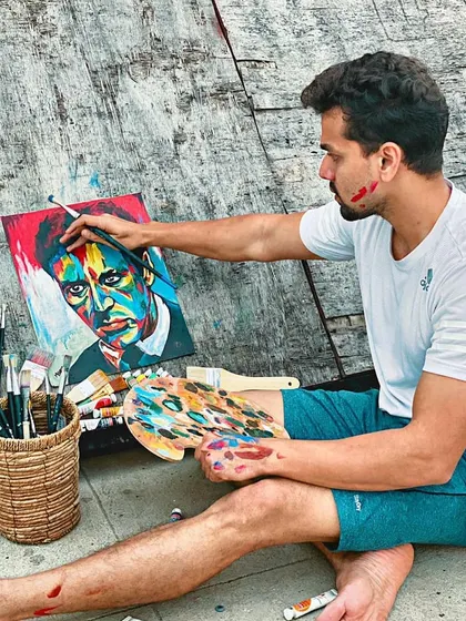 Another angle of me at work, deeply focused on the details of this colorful portrait. Each brushstroke is intentional, building up layers of color and emotion.
