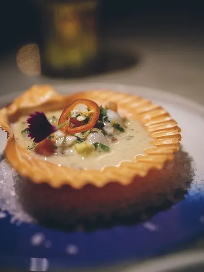 A delicate and creamy seafood dish served in a crispy, fluted pastry shell.