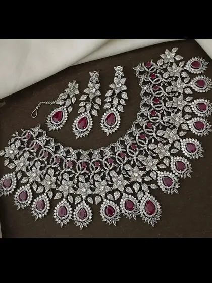 The same stunning CZ floral necklace set, but with deep ruby-red stones. You can rent this to match your outfit perfectly.
