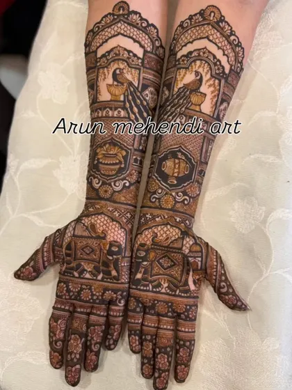 This design features beautiful peacocks and elephants, along with traditional kalash and floral patterns.