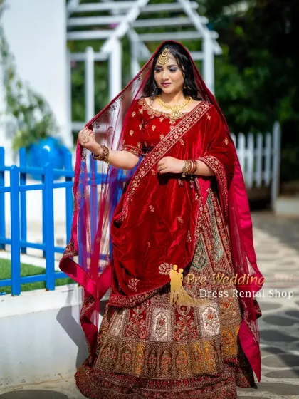 The model holds the edge of the sheer dupatta, showing its delicate embroidery and border.