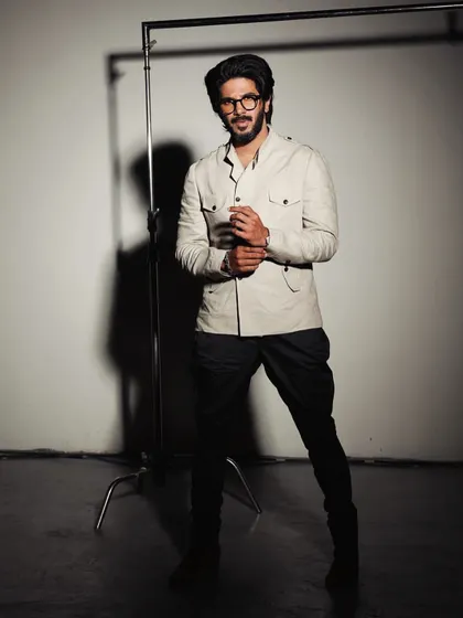 A throwback shot of Dulquer Salmaan. The safari-style jacket and dhoti pants create a unique fusion look that is both rugged and stylish.