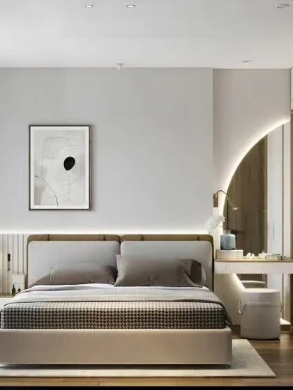 This bedroom design incorporates a built-in wardrobe with an integrated, semi-circular vanity nook. The warm backlighting and simple color palette create a soft, functional, and beautifully cohesive space.