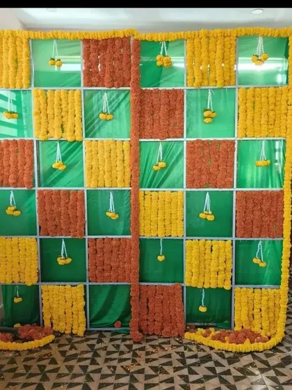 Here is the marigold chequered backdrop on its own. This versatile design serves as a fantastic photo wall for guests before the main seating is arranged, adding a splash of color to your event space.