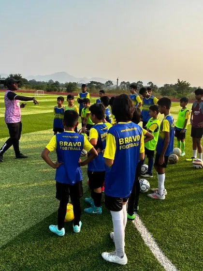 A coach from our partner club, NorthEast United FC, gives instructions to a group of young players during a camp. This highlights the high level of coaching our players receive.