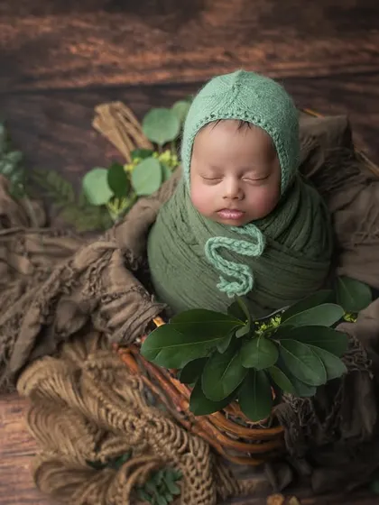 A rustic, woodland-themed setup using deep greens and natural browns. The addition of fresh leaves adds an organic touch.