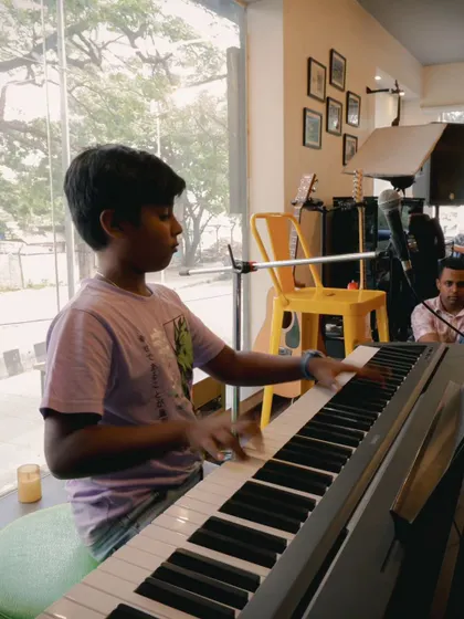 A student keyboardist performing at a recital. These events are a great way to track progress and celebrate achievements.