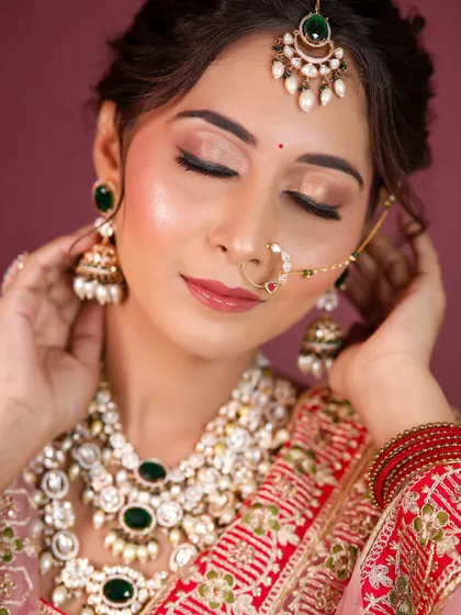 A detailed shot of the eye makeup, with soft brown and gold tones, and a flawless, glowing complexion.
