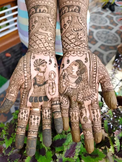 A close-up of the bride and groom portraits from a full bridal mehendi. The groom is shown with a lantern, and the bride is in her traditional attire, telling a unique story.