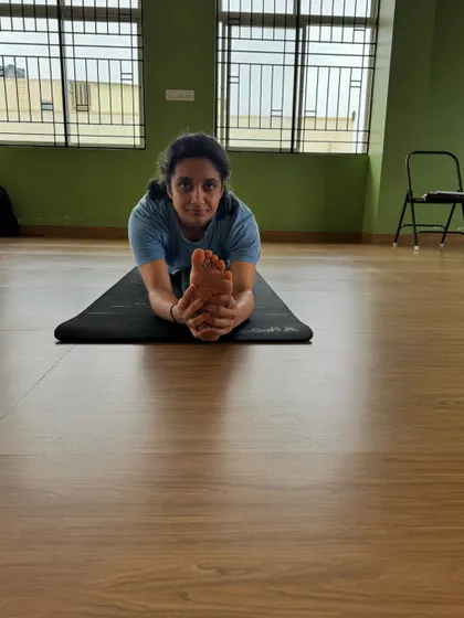 A close up of the forward fold in a split, showing the student's focus and the depth of the stretch. Every practice brings you closer to your goals.