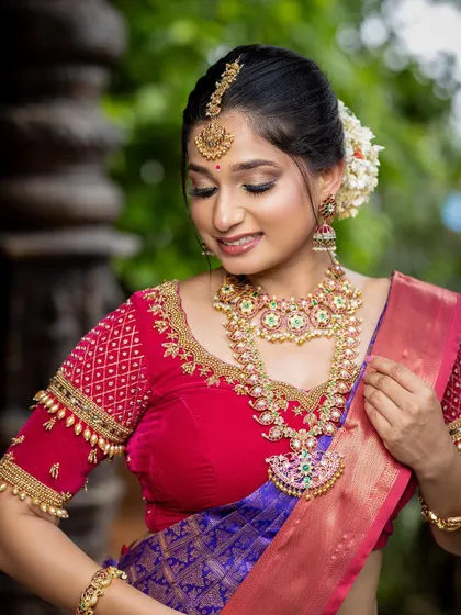 A beautiful, soft-focused shot highlighting the necklace set. The combination of kempu stones and pearls is truly classic.