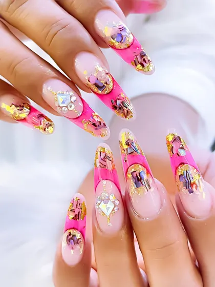 Another view of the pink inbuilt polygel nails, highlighting the sharp stiletto shape and the sparkling crystal accents.