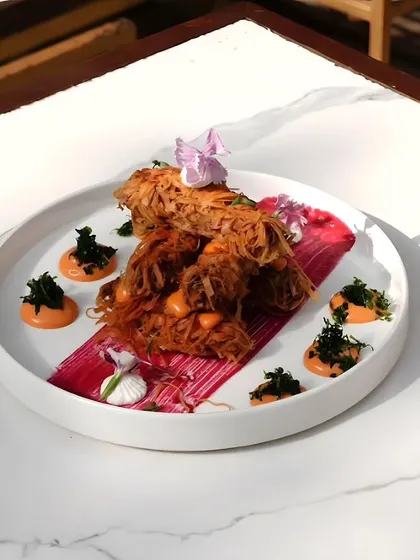 An artistically plated dish, showcasing the creativity of our chefs. The vibrant colors and delicate arrangement make it a work of edible art.